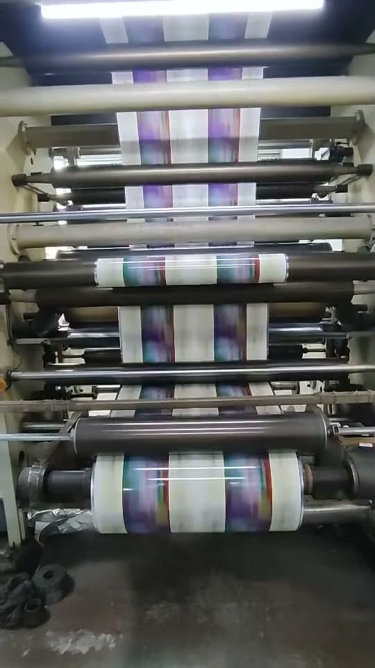 Printed film travelling through the stations of a printing press.