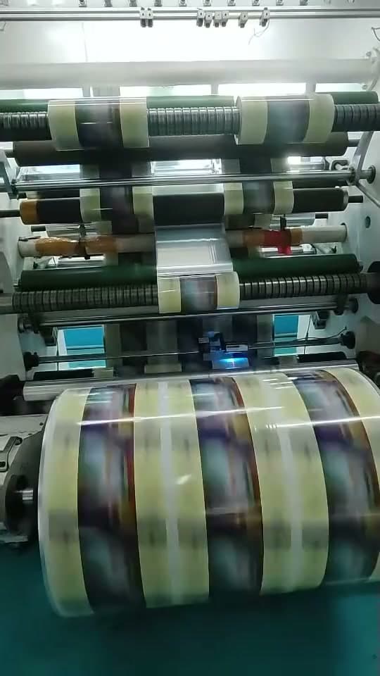 A slitter rewinder cutting a master roll into narrower rolls.